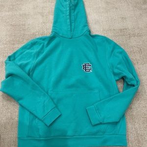 Eric Emanuel teal sweatshirt.